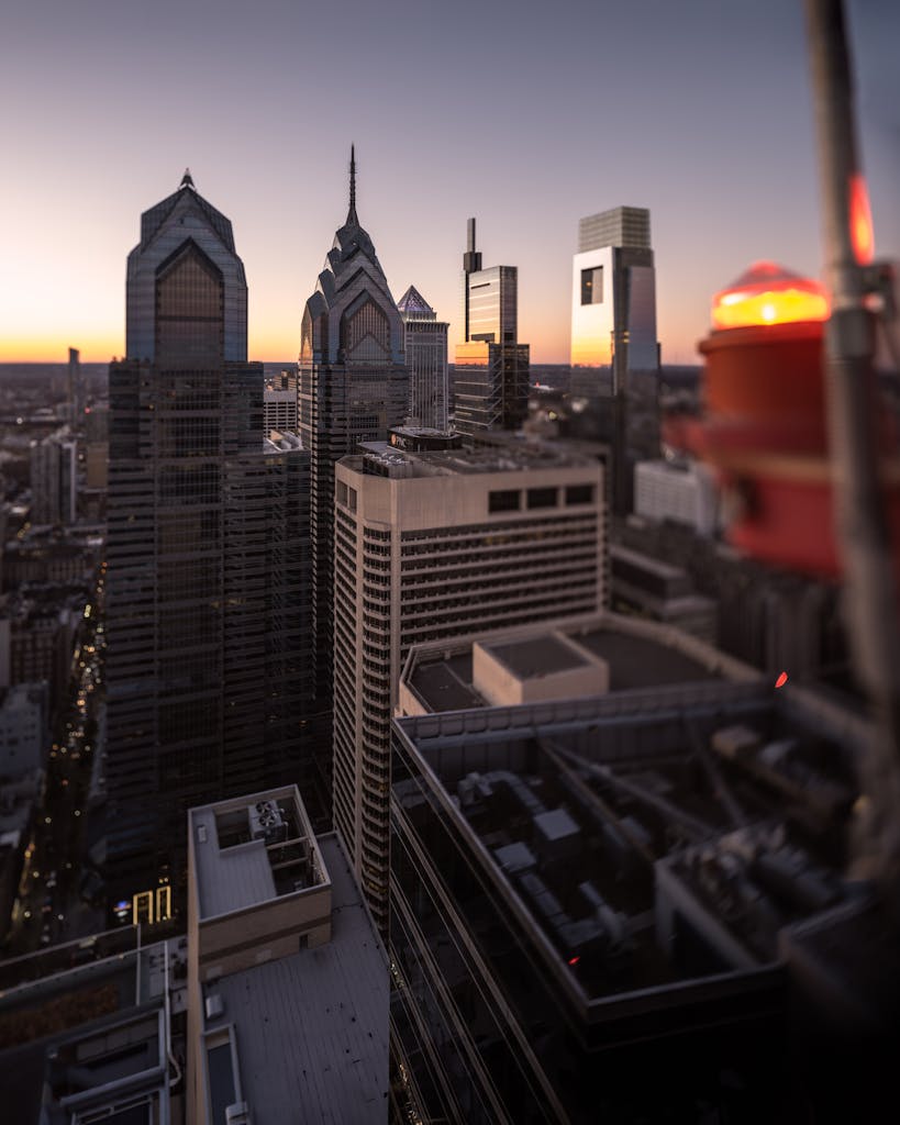 Stunning view of Philadelphia's skyline at sunset, capturing illuminated skyscrapers.